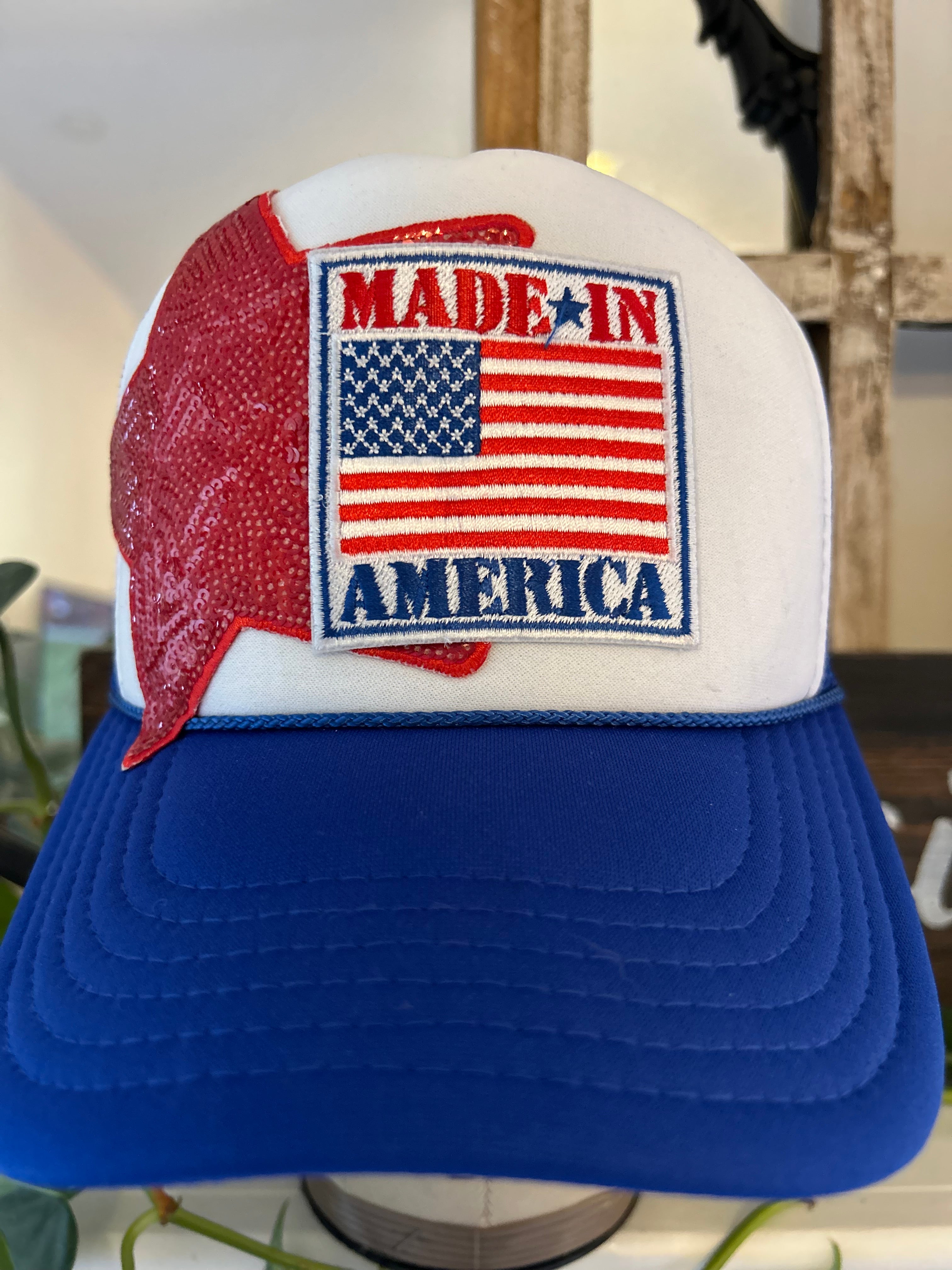 Blue and white trucker hat with 'Made in America' patch featuring American flag design 